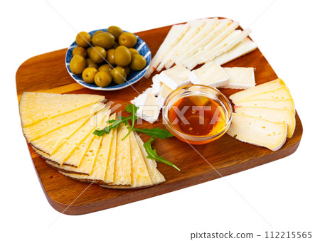 Sliced cheese served with honey and olives 112215565