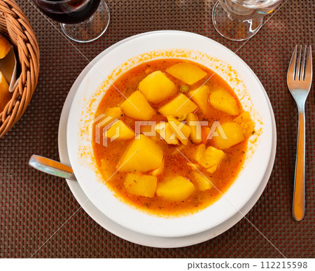 Stewed vegetables potatoes, carrots, onions in tomato sauce with cuttlefish 112215598