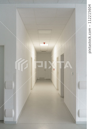 Hospital corridor, empty hospital hall. Modern medical clinic, closed doors. Vertical shot. 112215604