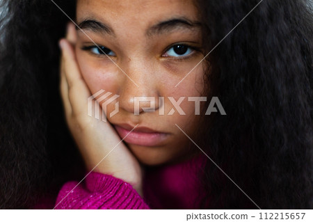 Portrait of bored woman holding her head in hand, looking at camera. Portrait of bored woman holding her head in hand, looking at camera. 112215657