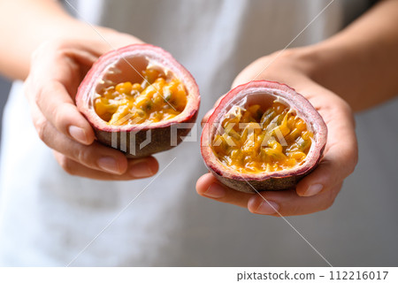 Passion fruit holding by hand, Tropical fruit in summer season 112216017