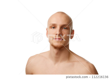 Portrait of handsome bald young guy in his 20s standing shirtless, looking at camera isolated against white studio background Portrait of handsome bald young guy in his 20s standing shirtless, looking at camera isolated against white studio background 112216136