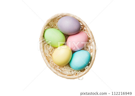 Basket of colorful Easter eggs isolated on white background. Easter basket filled with colored eggs top view holiday concept 112216949