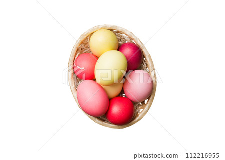 Basket of colorful Easter eggs isolated on white background. Easter basket filled with colored eggs top view holiday concept Basket of colorful Easter eggs isolated on white background. Easter basket filled with colored eggs top view holiday concept 112216955
