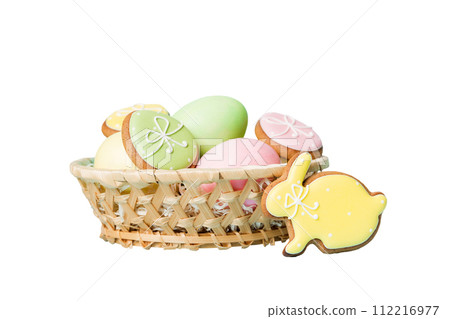 Colorful easter cookies in basket with Multi colors Easter eggs isolated on white background. Pastel color Easter eggs. holiday concept 112216977