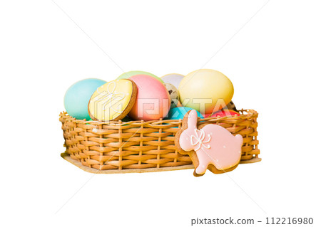 Basket of colorful Easter eggs isolated on white background. Easter basket filled with colored eggs top view holiday concept Basket of colorful Easter eggs isolated on white background. Easter basket filled with colored eggs top view holiday concept 112216980