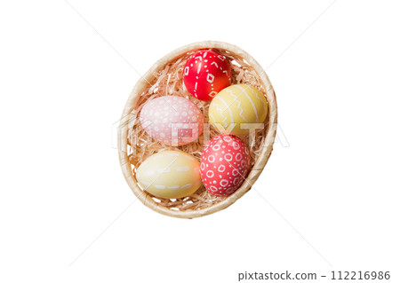 Basket of colorful Easter eggs isolated on white background. Easter basket filled with colored eggs top view holiday concept 112216986