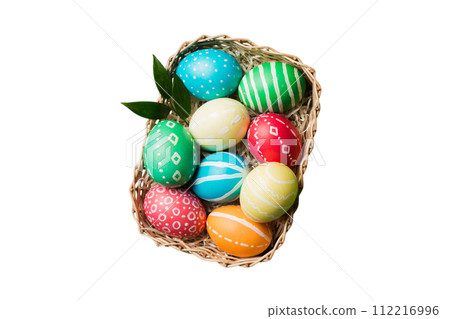 Basket of colorful Easter eggs isolated on white background. Easter basket filled with colored eggs top view holiday concept Basket of colorful Easter eggs isolated on white background. Easter basket filled with colored eggs top view holiday concept 112216996