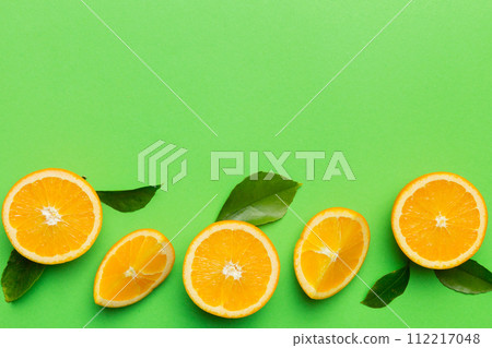 fresh Fruit orange slices on colored background. Top view. Copy Space. creative summer concept. Half of citrus in minimal flat lay with copy space 112217048