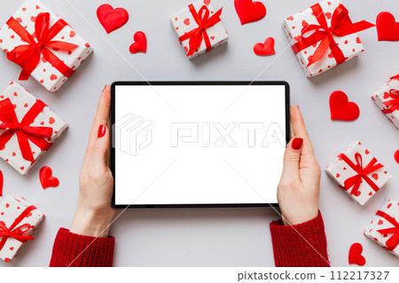 Female hands using a laptop for Valentine day background, gift box and envelope, hearts Female hands using a laptop for Valentine day background, gift box and envelope, hearts 112217327