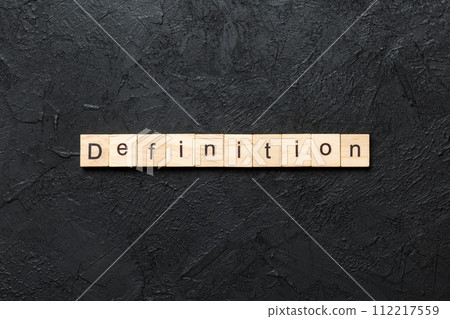 Definition word written on wood block. Definition text on cement table for your desing, concept 112217559