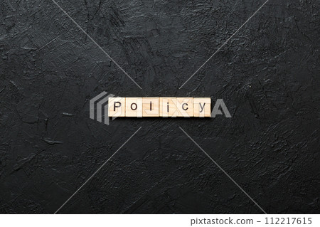 Policy word written on wood block. Policy text on cement table for your desing, concept Policy word written on wood block. Policy text on cement table for your desing, concept 112217615
