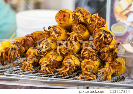 Close-up view of the grilled squid egg which is selling at the bazaar. 112217834