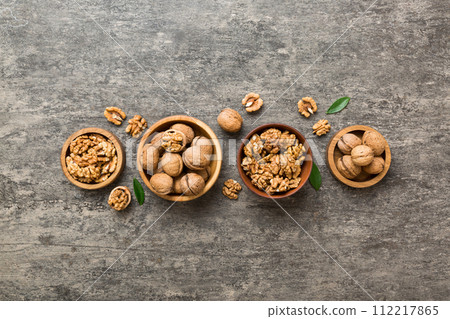 Walnut kernel halves, in a wooden bowl. Close-up, from above on colored background. Healthy eating Walnut concept. Super foods with copy space Walnut kernel halves, in a wooden bowl. Close-up, from above on colored background. Healthy eating Walnut concept. Super foods with copy space 112217865