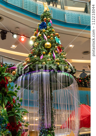 Beautiful Christmas decoration in Sunway Pyramid shopping mall. People can seen exploring and shopping around it. 112218044