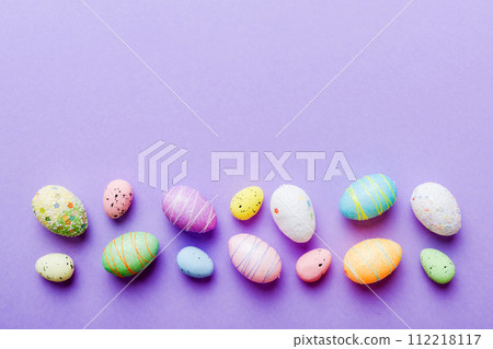 decorative easter eggs on colored background. easter eggs collection top view with copy space 112218117
