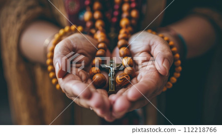 Hands Clasping a Rosary Hands Clasping a Rosary 112218766