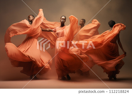 African-American dancers in fluttering orange fabric on a dark background African-American dancers in fluttering orange fabric on a dark background 112218824