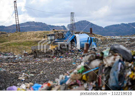 Garbage truck unloading waste on landfill, environmental concept. Garbage truck unloading waste on landfill, environmental concept. 112219010