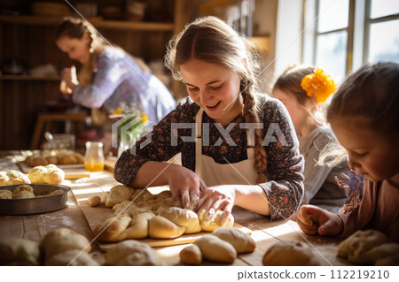 Children preparing homemade cakes in the kitchen. Easter bread backing class 112219210