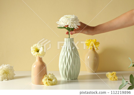 Fresh flowers in a vase on a light background. Fresh flowers in a vase on a light background. 112219896