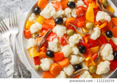 Homemade Insalata Di Rinforzo cauliflower salad with pickled, olive, anchovy closeup on the plate. Horizontal top view 112220259