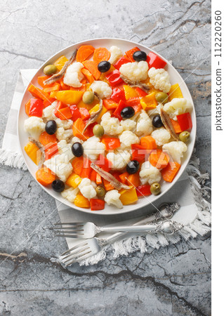 Insalata Di Rinforzo Italian classic the Neapolitan Christmas cauliflower salad closeup on the plate. Vertical top view 112220260