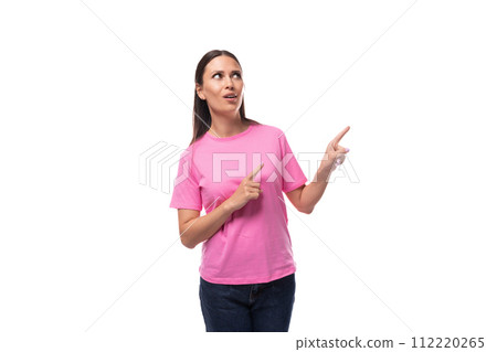 young stylish woman with straight black hair dressed in a pink t-shirt points her hand to the side young stylish woman with straight black hair dressed in a pink t-shirt points her hand to the side 112220265
