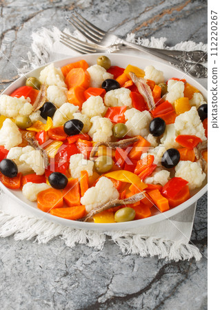 Insalata Di Rinforzo Italian classic the Neapolitan Christmas cauliflower salad closeup on the plate. Vertical 112220267