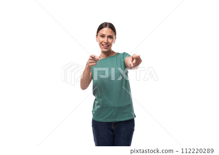 attractive young caucasian woman in a t-shirt points with her index finger 112220289