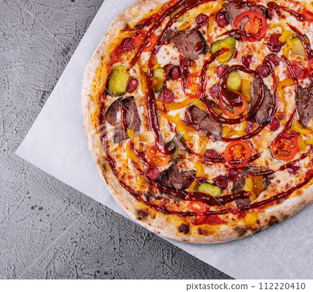 Italian pizza with sausage, meat and cucumbers Italian pizza with sausage, meat and cucumbers 112220410