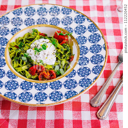 Plate of delicious pasta with pesto sauce on table Plate of delicious pasta with pesto sauce on table 112220452