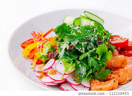 Smoked or salted salmon salad with cucumbers, arugula, peppers and radishes Smoked or salted salmon salad with cucumbers, arugula, peppers and radishes 112220453