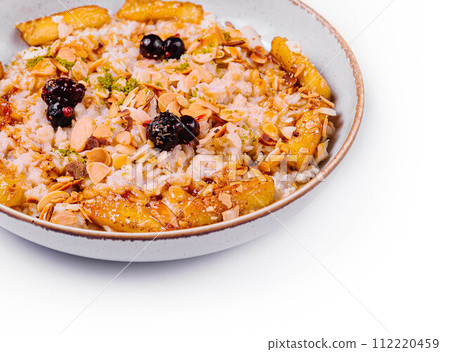 Muesli with dried fruits and milk in ceramic bowl Muesli with dried fruits and milk in ceramic bowl 112220459