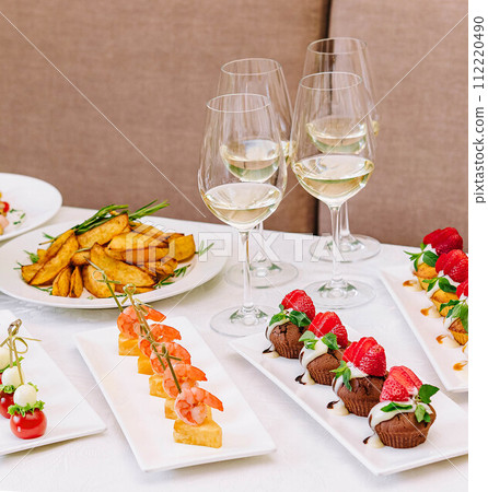table with different gourmet snacks for white wine table with different gourmet snacks for white wine 112220490