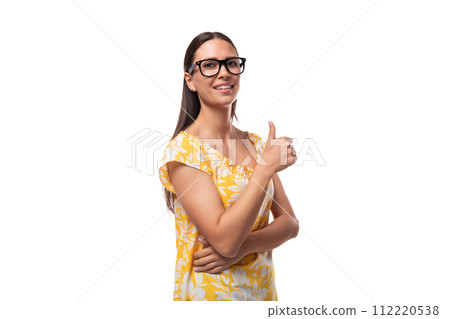 attractive young woman with glasses for vision correction shows class with her hand attractive young woman with glasses for vision correction shows class with her hand 112220538