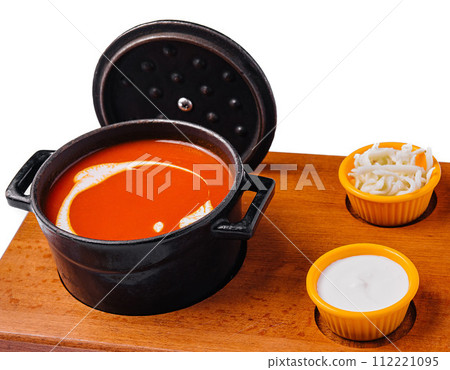 Tomato soup gazpacho in stewpan and suluguni cheese 112221095
