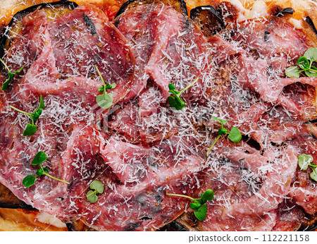 rectangular pizza with eggplant and prosciutto 112221158