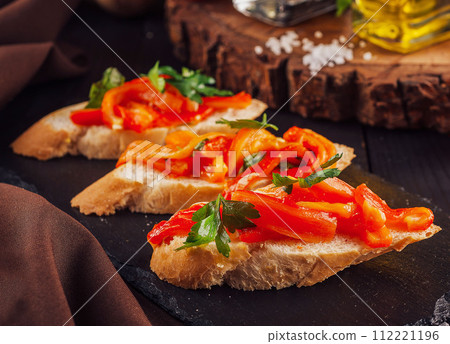 Bruschettas on cutting board close up Bruschettas on cutting board close up 112221196