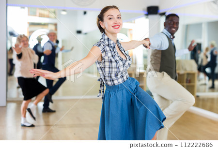 Man and woman performing jazz dance in dancing room 112222686