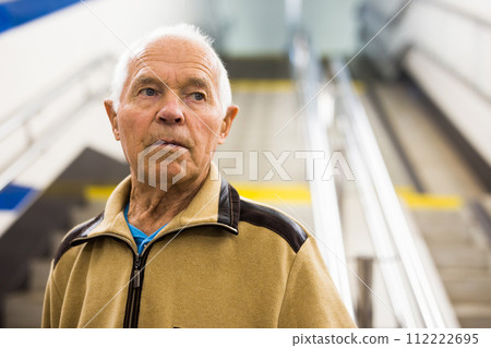 Senior man walking down the stairs to subway station 112222695