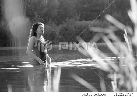 Happy blonde woman having fun in sunny park smiling, fooling around, laughing. Slow Motion. Beautiful caucasian girl dancing under the summer rain. wet hair and clothes. enjoying with drops. Happy blonde woman having fun in sunny park smiling, fooling around, laughing. Slow Motion. Beautiful caucasian girl dancing under the summer rain. wet hair and clothes. enjoying with drops. 112222734