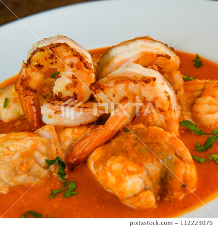 Recipe for Armorican-style monkfish tail, prawns, flambees with cognac Recipe for Armorican-style monkfish tail, prawns, flambees with cognac 112223076