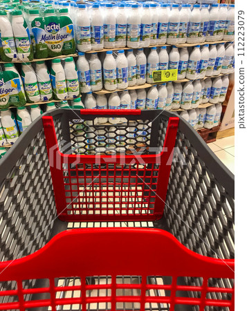 Caddy in a supermarket in front of packs of milk Caddy in a supermarket in front of packs of milk 112223079