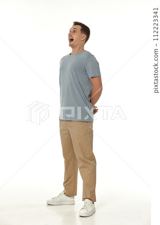 surprised guy looking at camera on white studio background 112223341