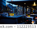 Twilight taxi car in city center during rush hour traffic 112223513