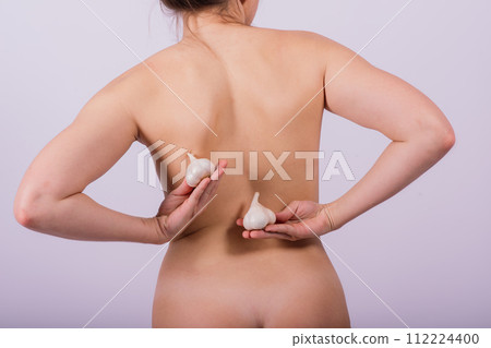 Young nude woman with garlic, naked body Young nude woman with garlic, naked body 112224400