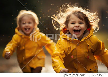 Joyous Autumn Splash Playful Children in Yellow Raincoats Dancing Through Puddles on a Rainy Day Stroll. created with Generative AI Joyous Autumn Splash Playful Children in Yellow Raincoats Dancing Through Puddles on a Rainy Day Stroll. created with Generative AI 112224569