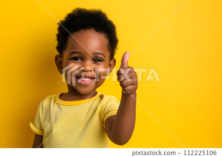 Cheerful Toddler Giving Thumbs Up on Solid colored Background Cheerful Toddler Giving Thumbs Up on Solid colored Background 112225106