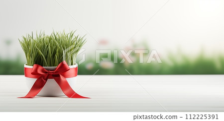 AI-generated content. Happy Nowruz holiday background. Green wheat grass semeni tied with a red bow. Simple Nowruz symbol background 112225391